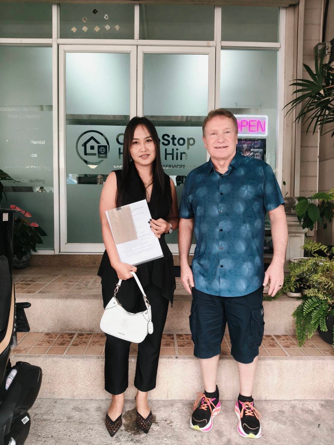 OneStop Hua Hin team member with client outside the office